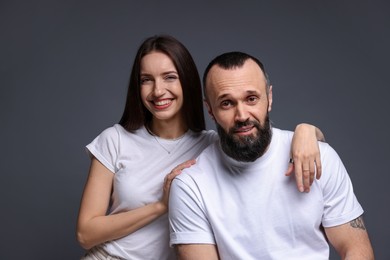 Photo of Portrait of happy daughter and father on dark grey background