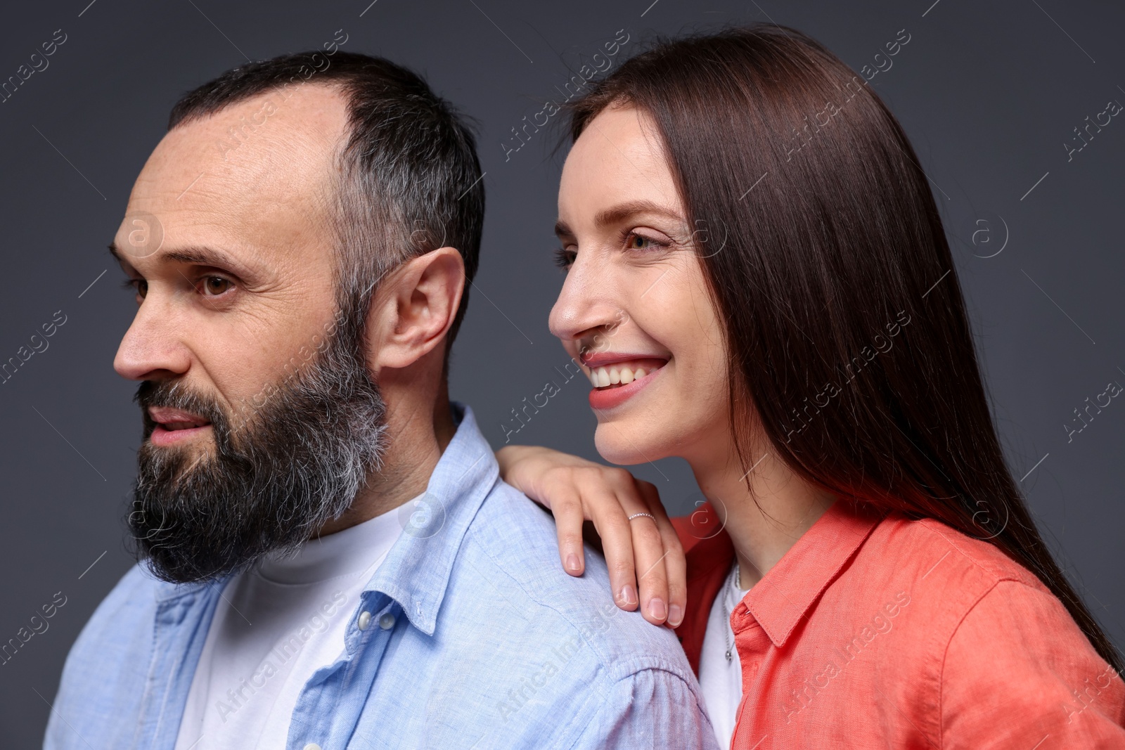 Photo of Happy daughter and father on dark grey background