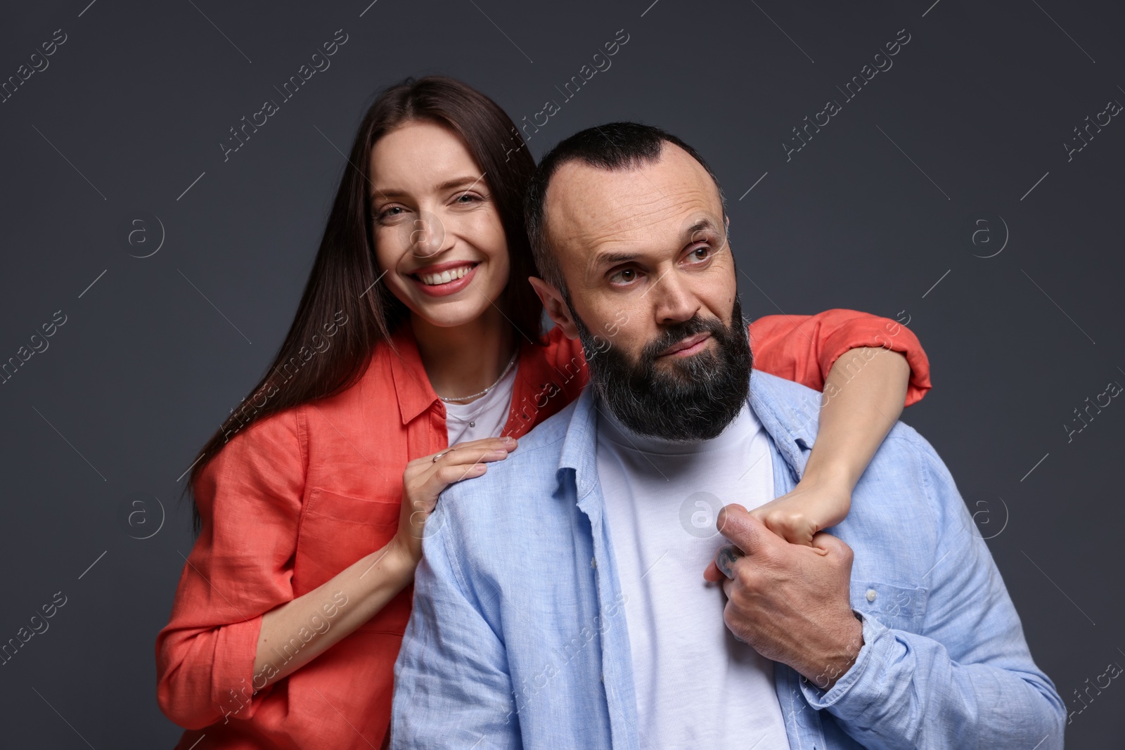 Photo of Happy daughter and father on dark grey background