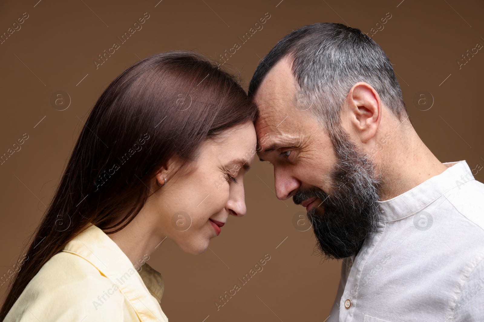 Photo of Happy daughter and father on brown background