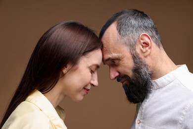 Photo of Happy daughter and father on brown background