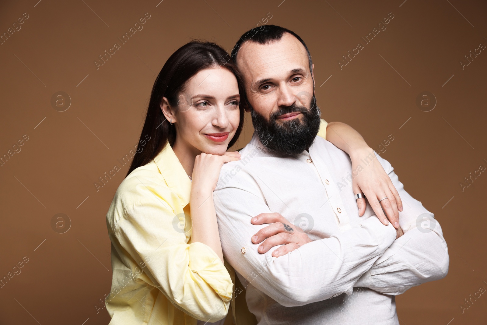 Photo of Happy daughter and father on brown background