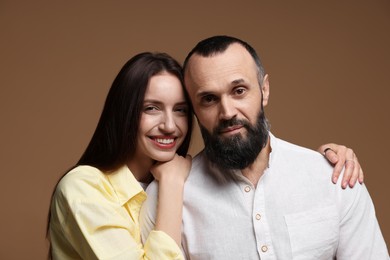 Photo of Portrait of happy daughter and father on brown background