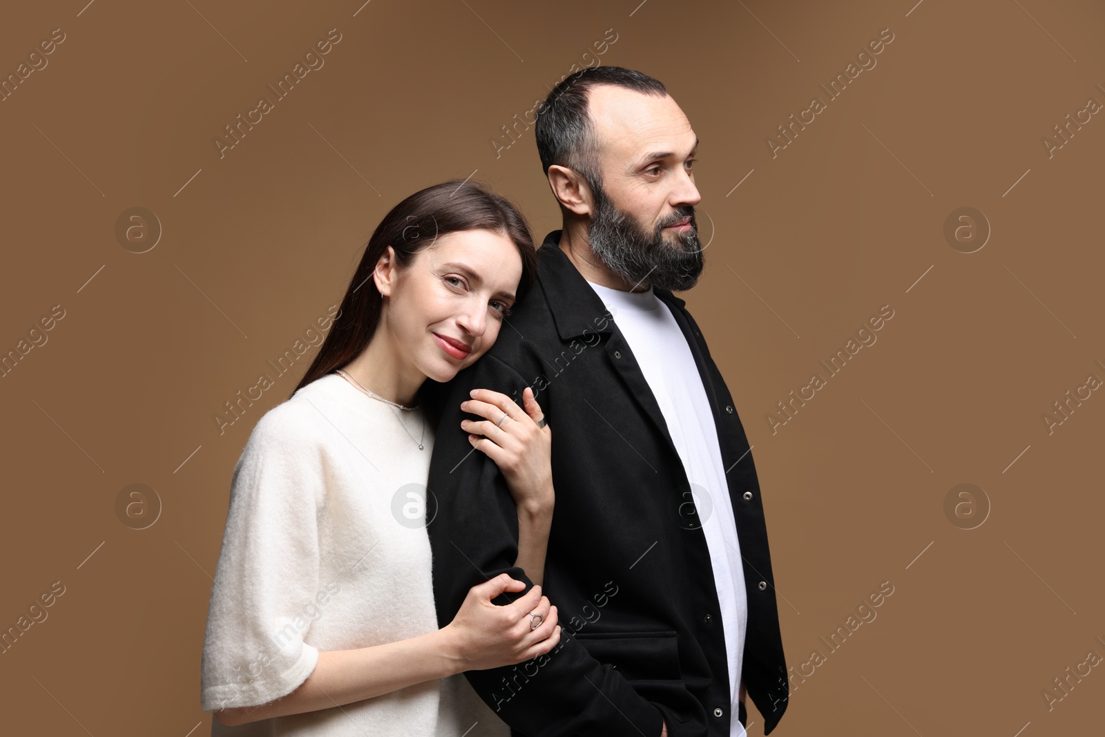 Photo of Cute daughter and father on brown background