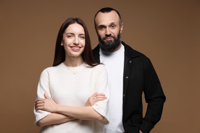 Photo of Portrait of happy daughter and father on brown background