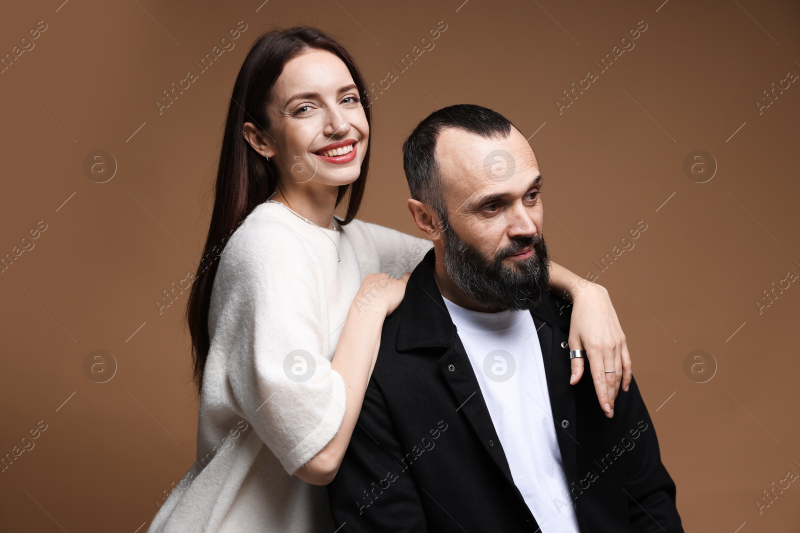 Photo of Happy daughter and father on brown background