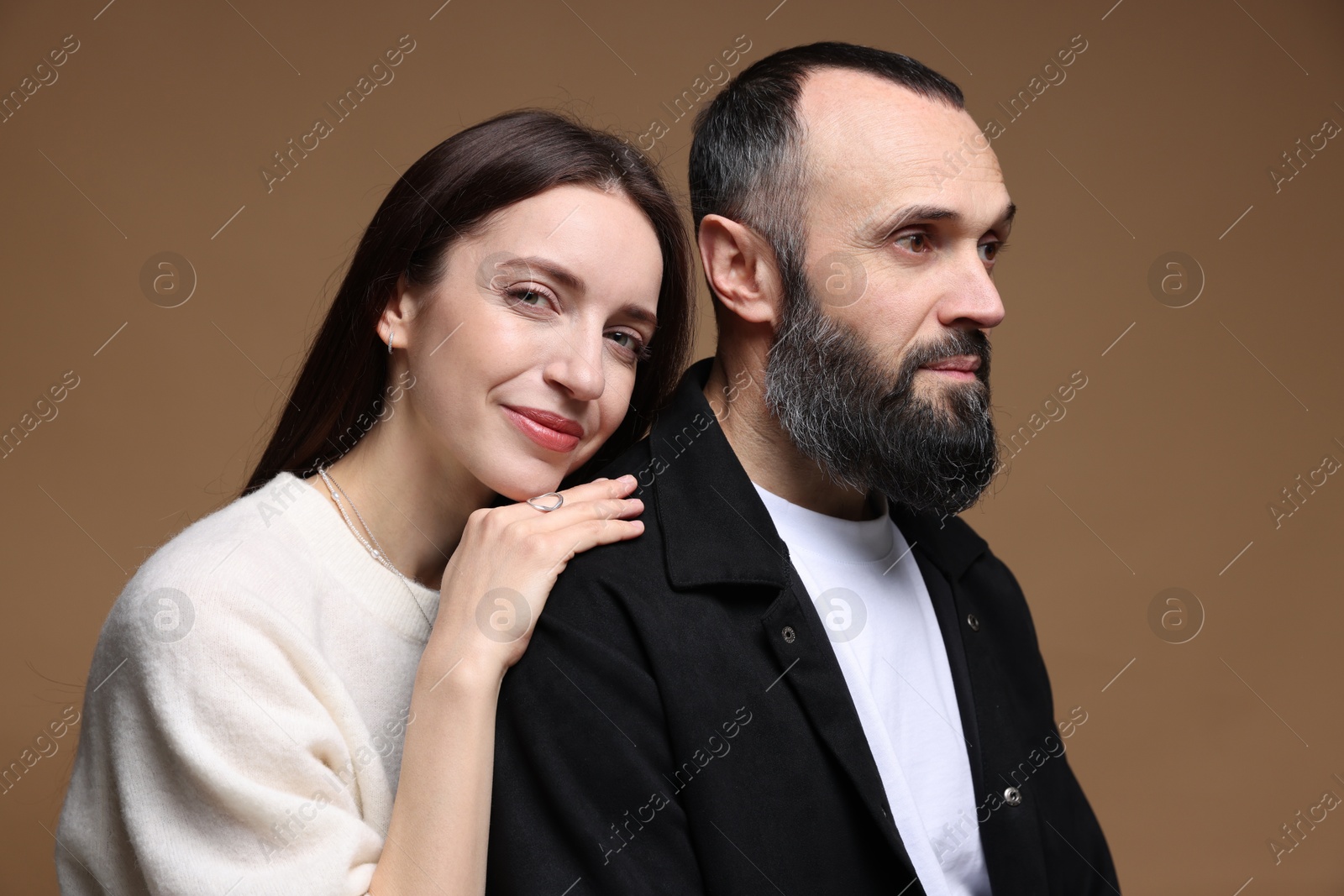 Photo of Cute daughter and father on brown background