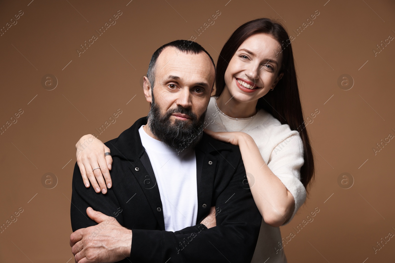 Photo of Portrait of happy daughter and father on brown background