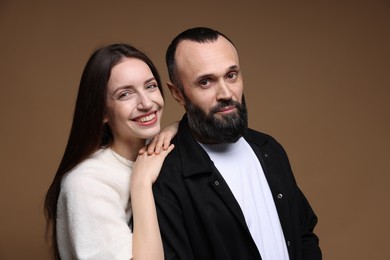 Photo of Portrait of happy daughter and father on brown background