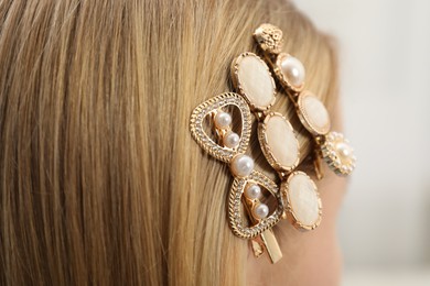 Photo of Woman with beautiful hair clips on blurred background, closeup