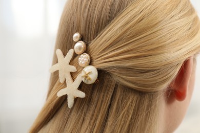 Photo of Woman with beautiful hair clips on blurred background, closeup