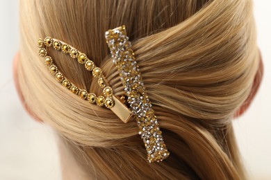 Photo of Woman with beautiful hair clips on blurred background, closeup