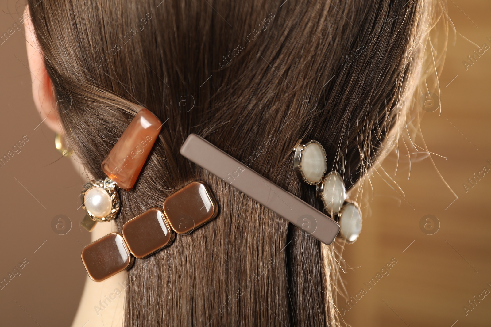 Photo of Woman with beautiful hair clips on blurred background, closeup