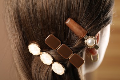 Photo of Woman with beautiful hair clips on blurred background, closeup