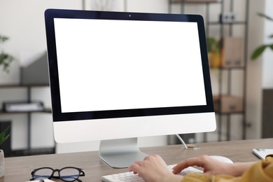 Photo of Woman working on computer at wooden desk in office, closeup. Mockup for design