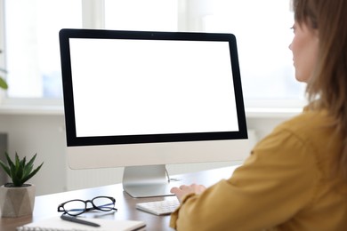 Photo of Woman working on computer at desk in office. Mockup for design