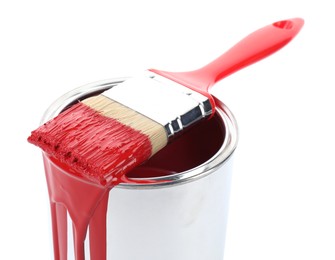 Photo of Can of red paint and brush isolated on white