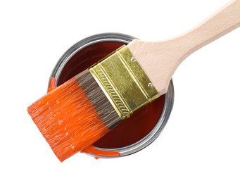 Photo of Can of orange paint and brush isolated on white, top view