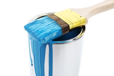 Photo of Can of light blue paint and brush isolated on white