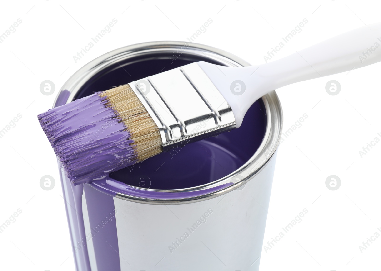 Photo of Can of violet paint and brush isolated on white