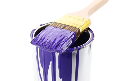 Photo of Can of violet paint and brush isolated on white