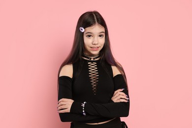 Photo of Teenage girl posing on pink background. Makeup and clothes in anime style