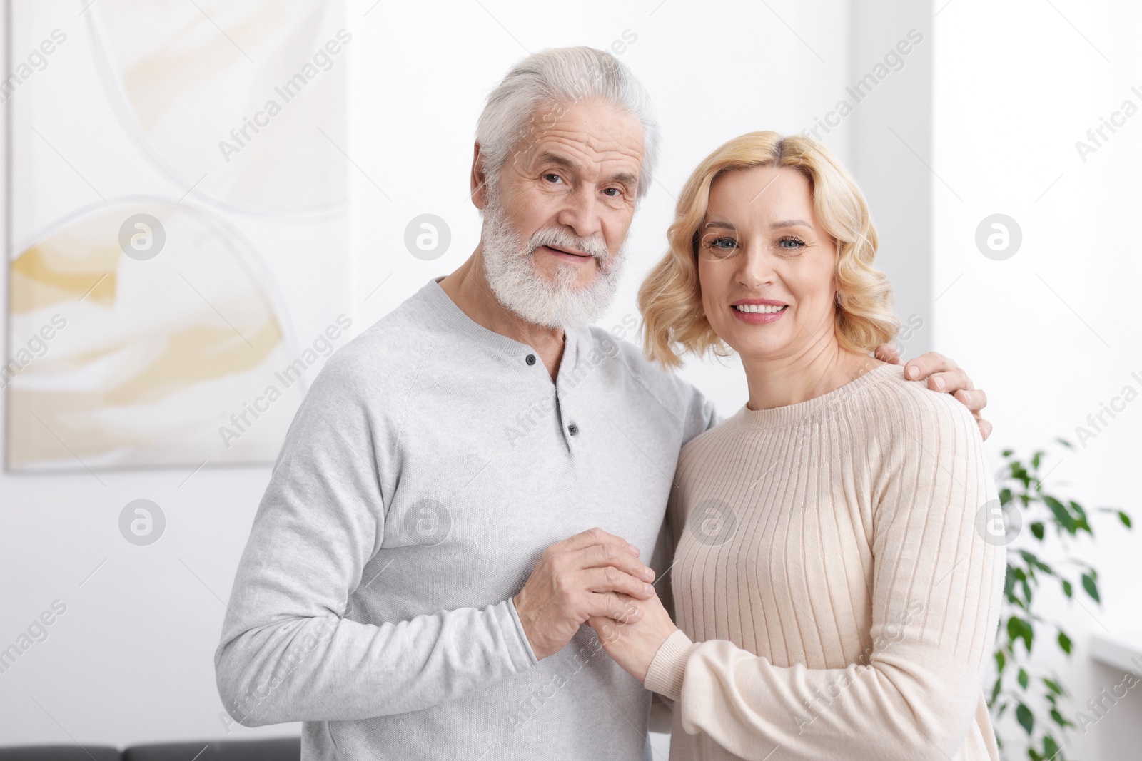 Photo of Senior man and mature woman at home. Happy couple