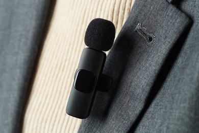 Photo of Woman with lavalier microphone on her shirt, closeup