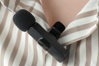 Photo of Woman with lavalier microphone on her shirt, closeup