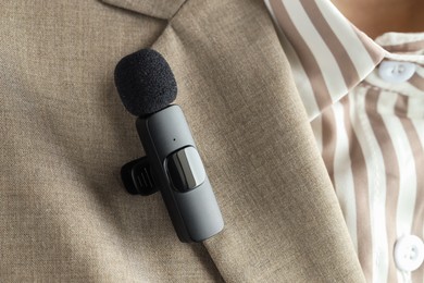 Photo of Woman with lavalier microphone on her shirt, closeup