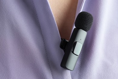 Photo of Woman with lavalier microphone on her shirt, closeup