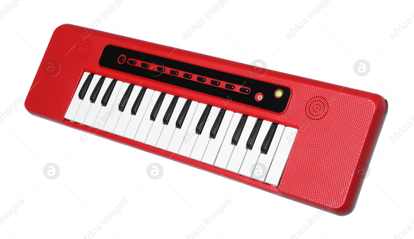 Photo of Red toy electric piano isolated on white. Child's musical instrument