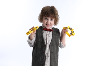 Photo of Cute little boy playing toy tambourines on white background