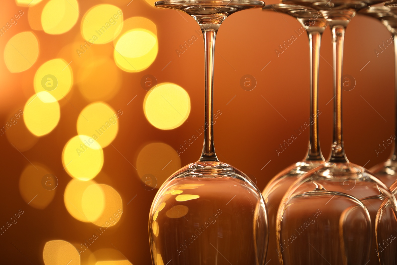 Many clean glasses against blurred lights, closeup. Bokeh effect Photo of Many clean glasses against blurred lights, closeup. Bokeh effect