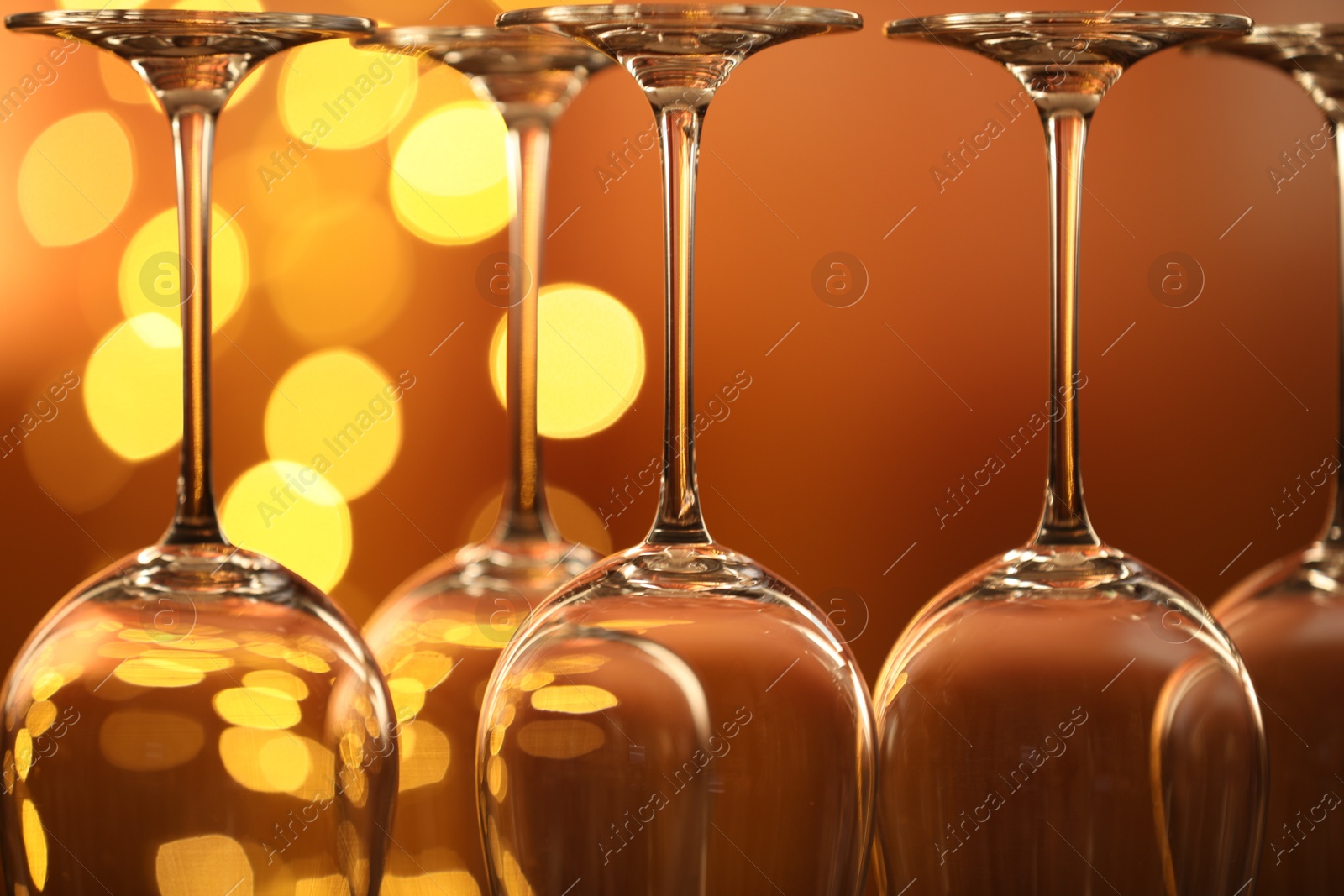 Many clean glasses against blurred lights, closeup. Bokeh effect Photo of Many clean glasses against blurred lights, closeup. Bokeh effect