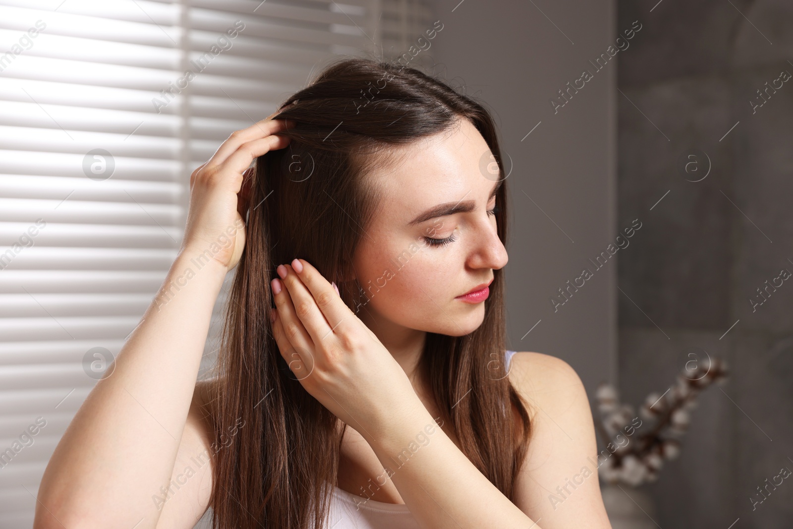 Photo of Beautiful woman with healthy hair roots at home