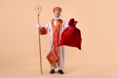 Photo of Saint Nicholas with sack on beige background