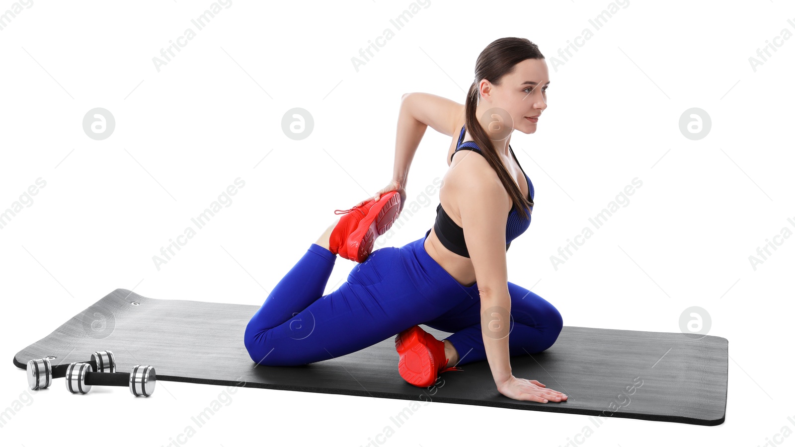 Photo of Woman in sportswear exercising on white background