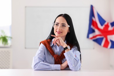 Photo of Portrait of English teacher at desk in classroom