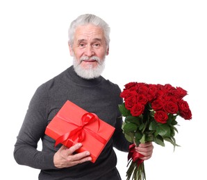 Photo of Senior man with bouquet of red roses and gift box on white background