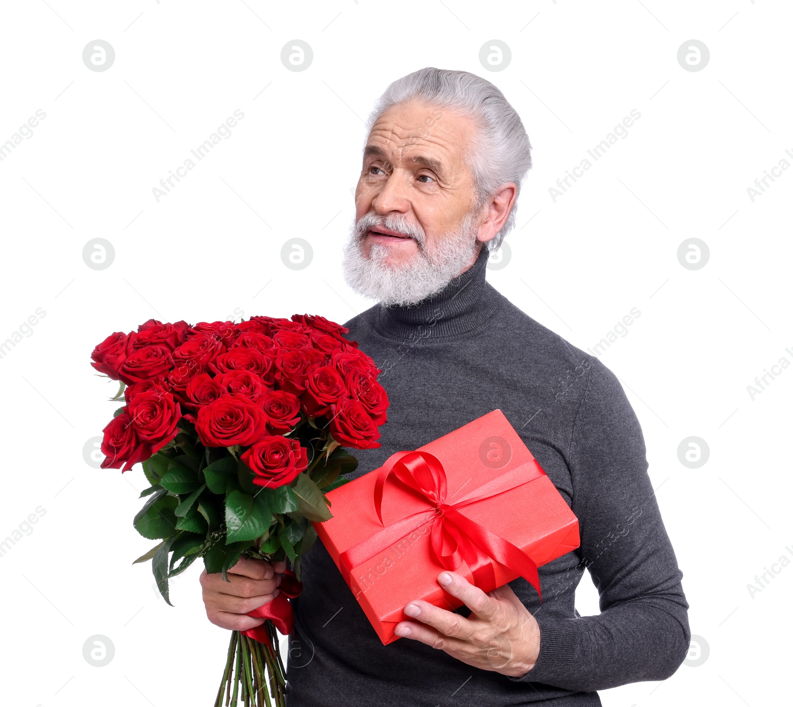 Photo of Senior man with bouquet of red roses and gift box on white background