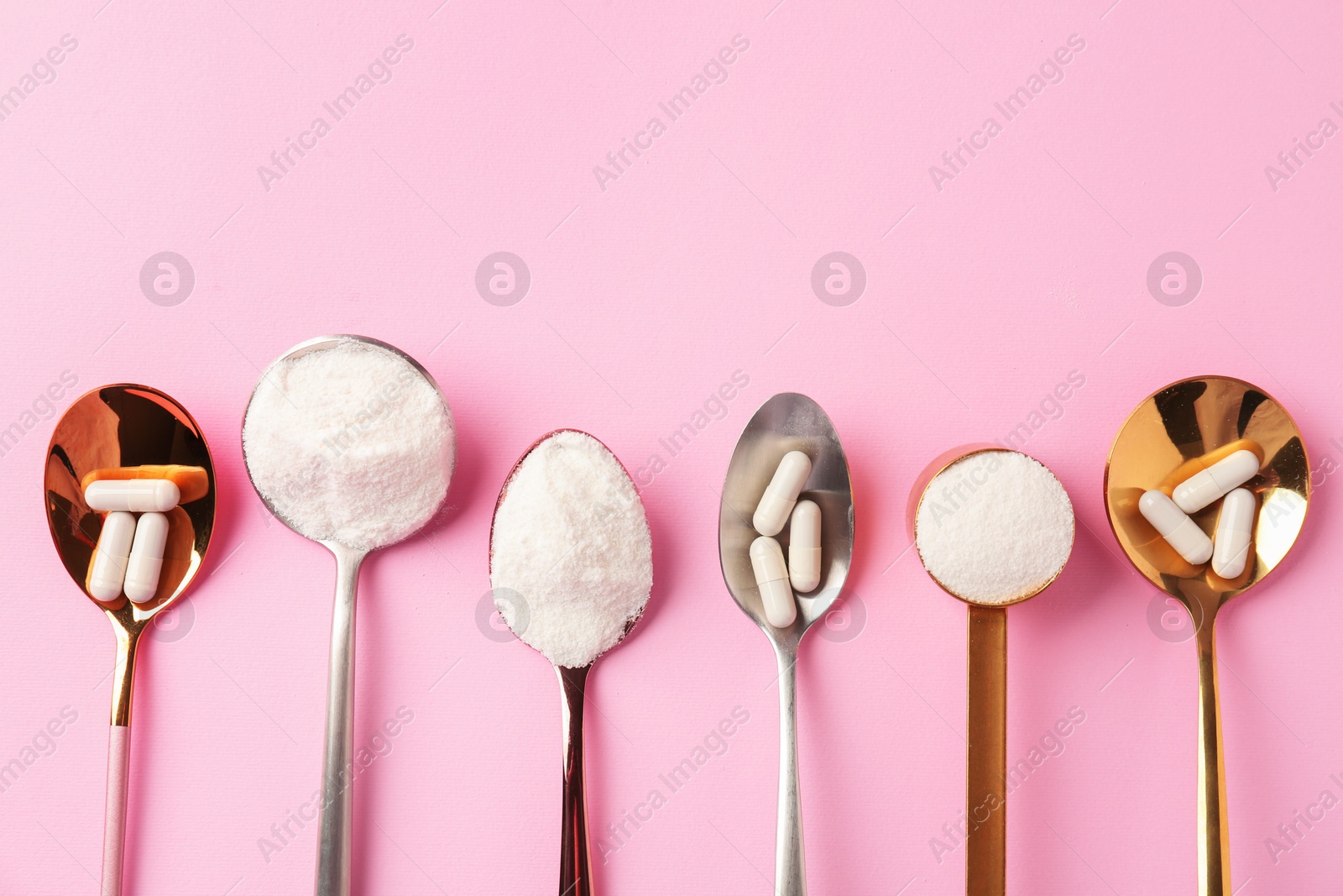 Collagen powder and pills on pink background, flat lay. Space for text Photo of Collagen powder and pills on pink background, flat lay. Space for text