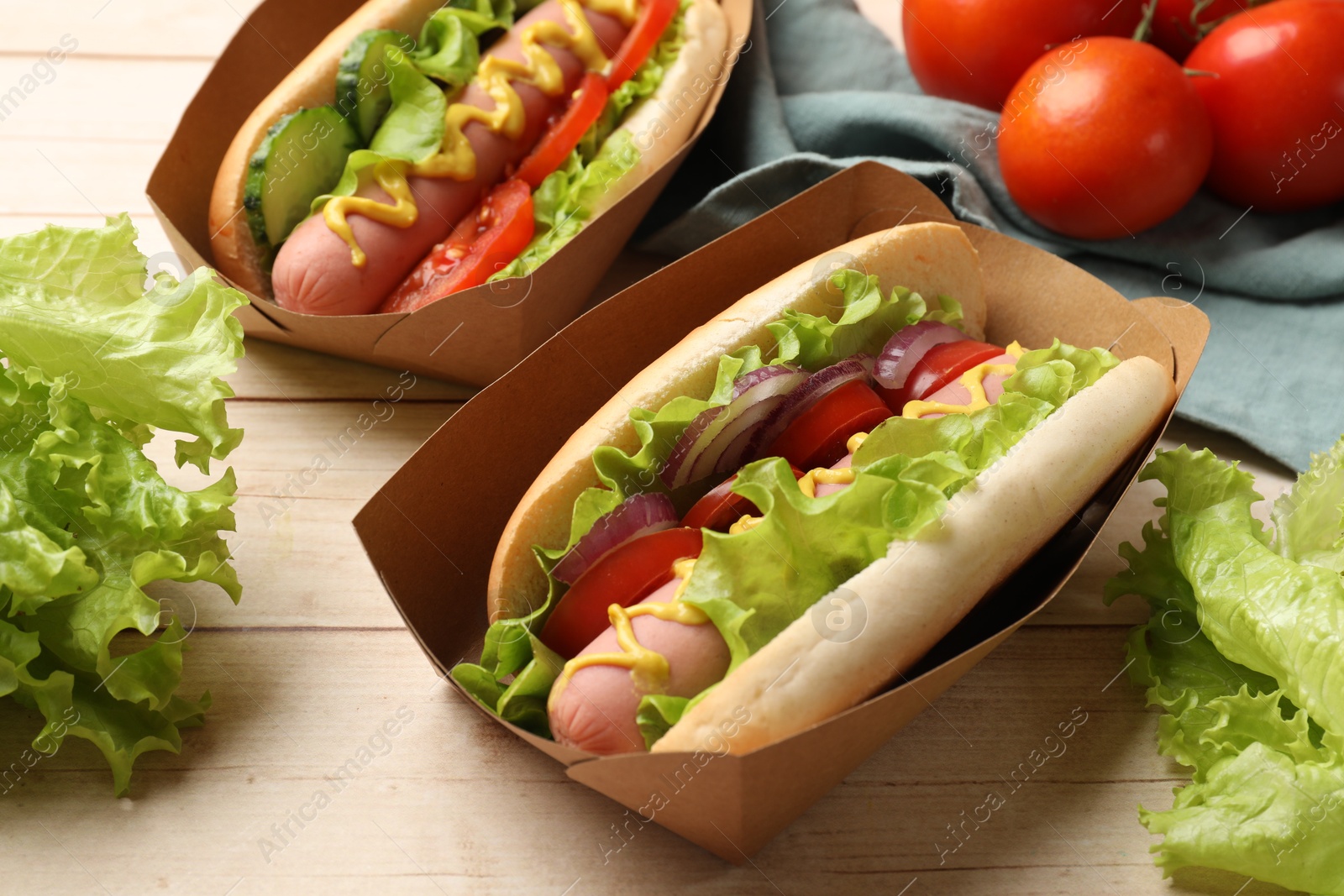 Tasty hot dogs on wooden table, closeup Photo of Tasty hot dogs on wooden table, closeup