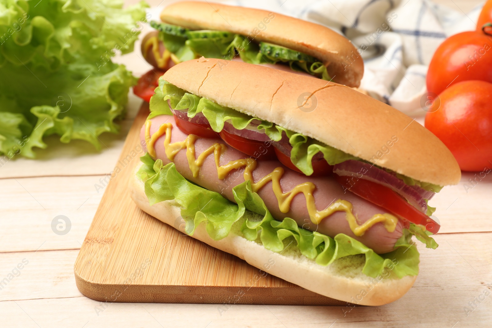 Tasty hot dogs on wooden table, closeup Photo of Tasty hot dogs on wooden table, closeup