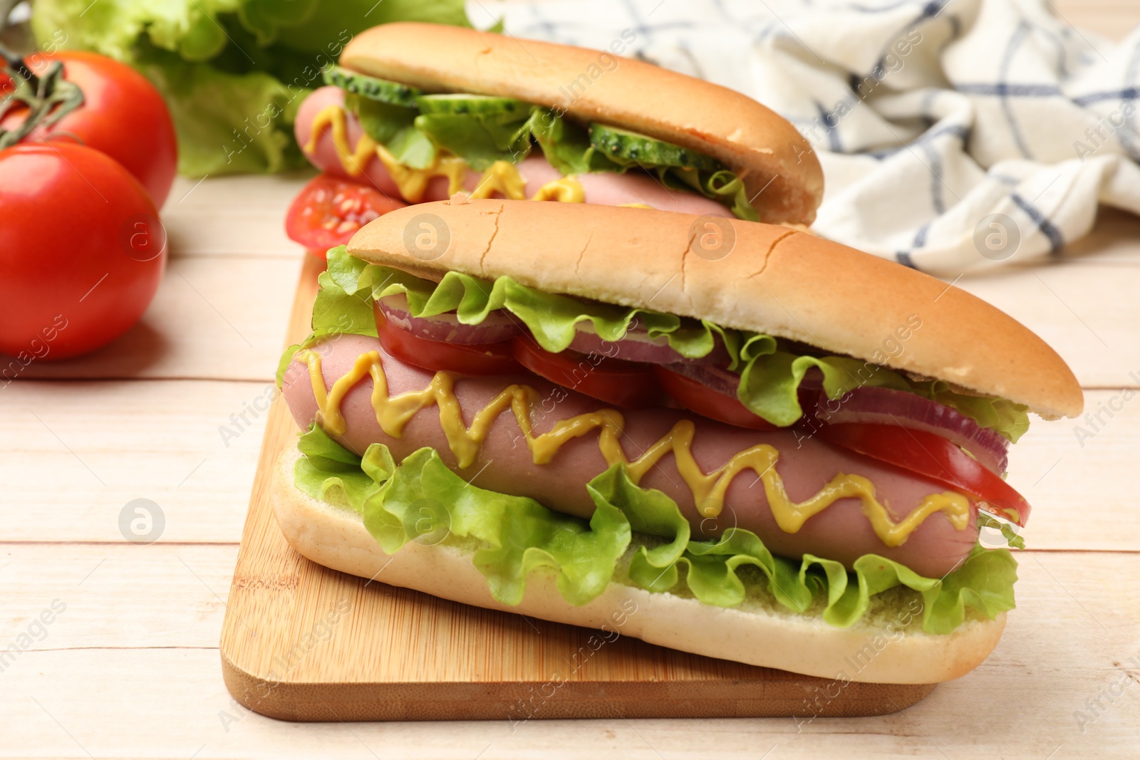 Tasty hot dogs on wooden table, closeup Photo of Tasty hot dogs on wooden table, closeup