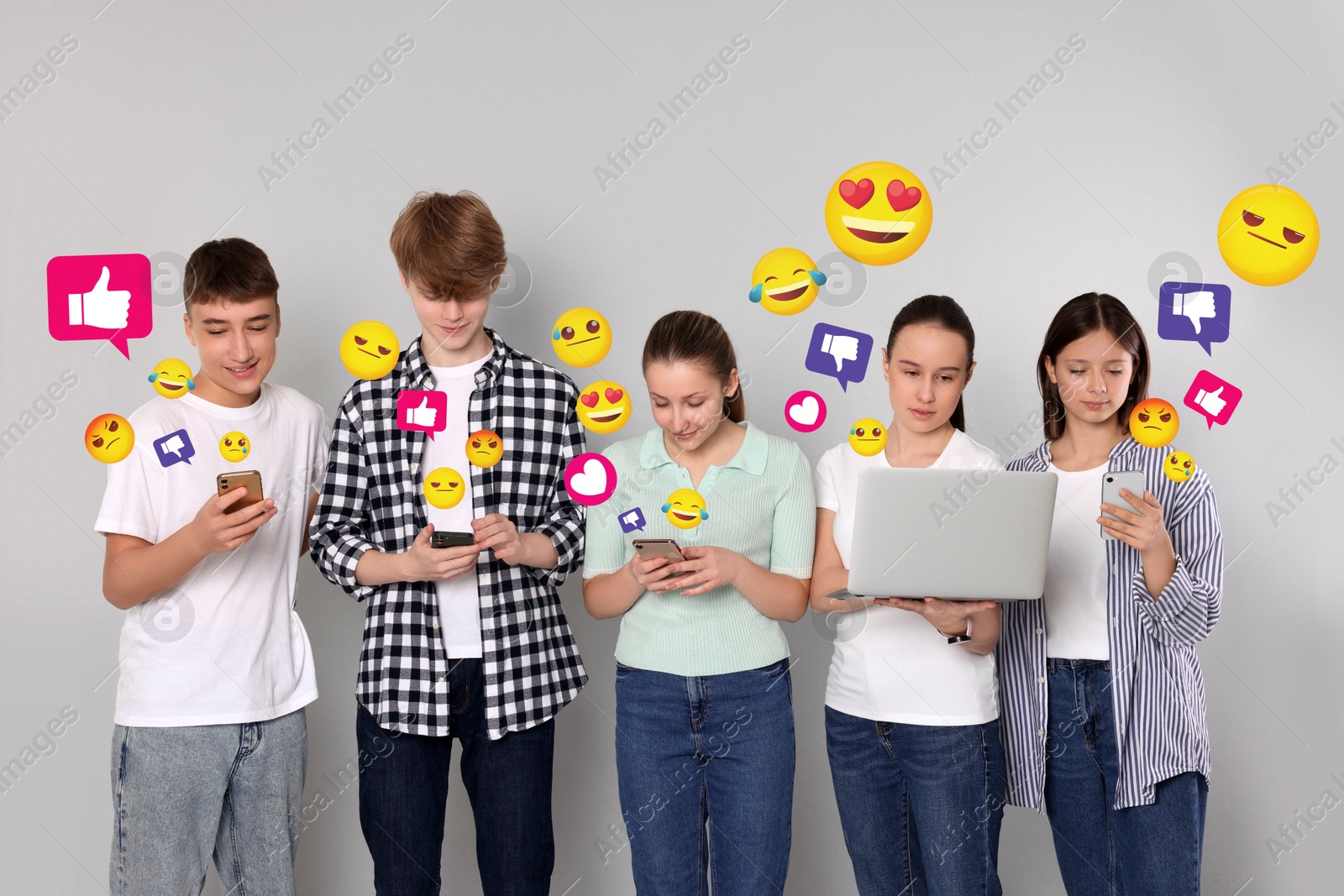 Image of Social media. Group of teenagers using different gadgets on light grey background. Different notification signs and emojis near them