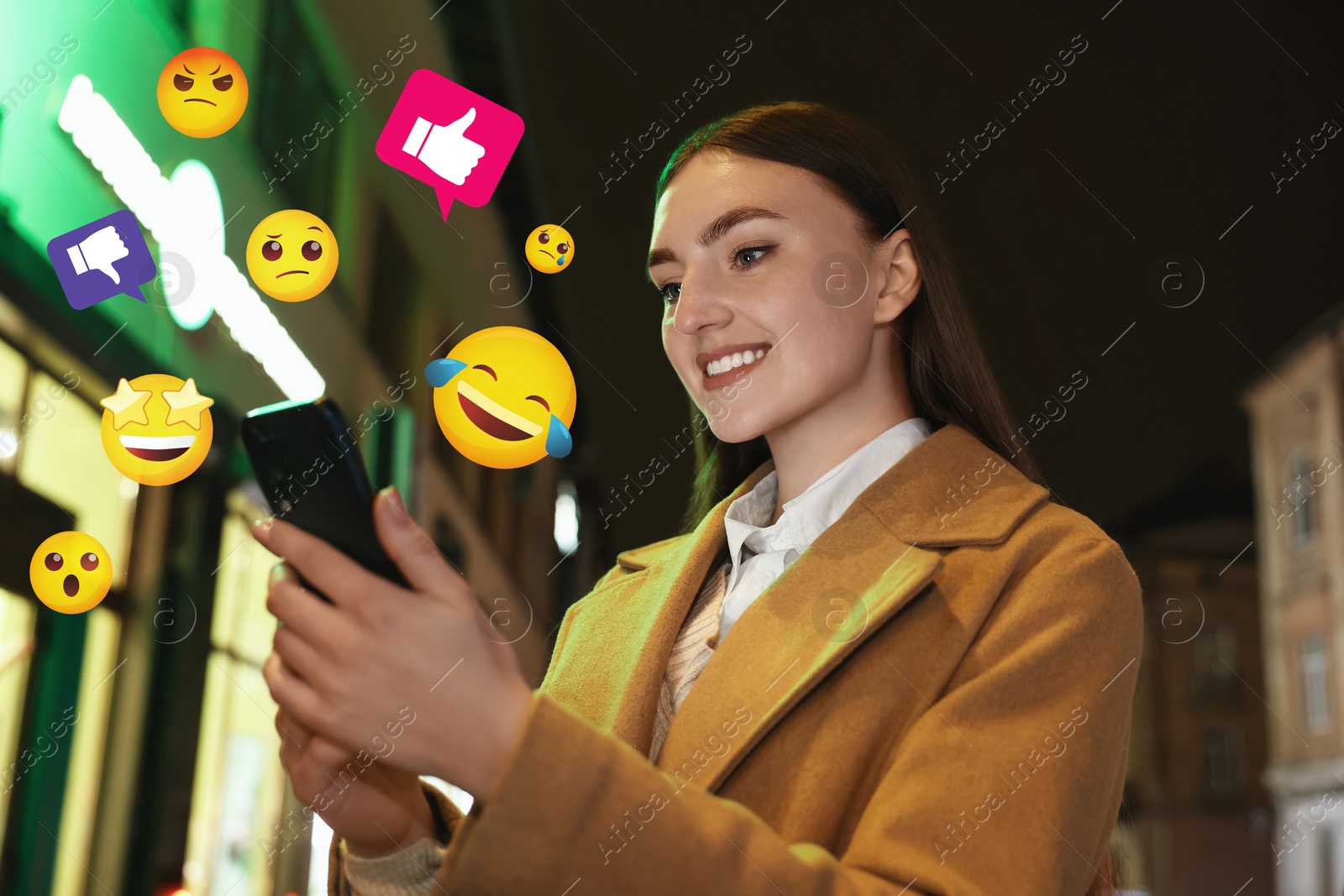 Image of Social media. Happy woman using mobile phone outdoors. Different notification signs and emojis near gadget