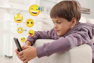 Image of Social media. Cute boy using mobile phone at home. Different emojis near gadget