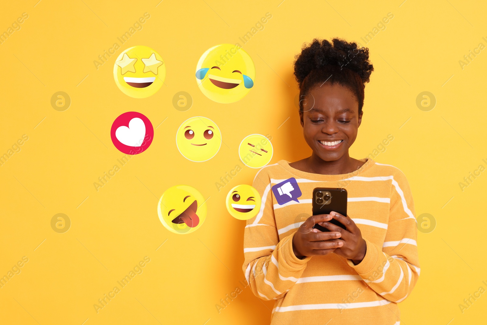 Image of Social media. Happy woman using mobile phone on orange background. Different notification signs and emojis near gadget