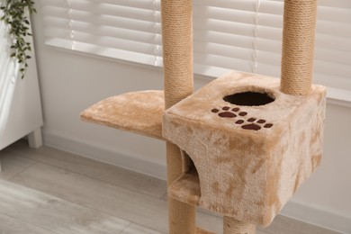 Photo of Stylish cat tree in living room, closeup